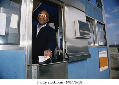 NEW JERSEY - CIRCA 1980's: Attendant at toll booth in New Jersey, USA