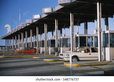 NEW JERSEY - CIRCA 1980's: Cars emerging from toll booth in New Jersey