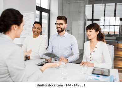 new job, hiring and employment concept - international team of recruiters having interview with female employee at office - Shutterstock ID 1447142351