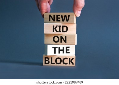 New kid on the block symbol. Concept words New kid on the block on wooden blocks. Businessman hand. Beautiful grey table grey background. Business and new kid on the block concept. Copy space.
