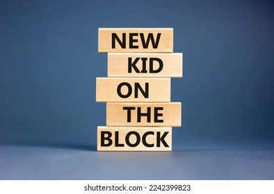 New kid on the block symbol. Concept words New kid on the block on wooden blocks. Beautiful grey table grey background. Business and new kid on the block concept. Copy space.
