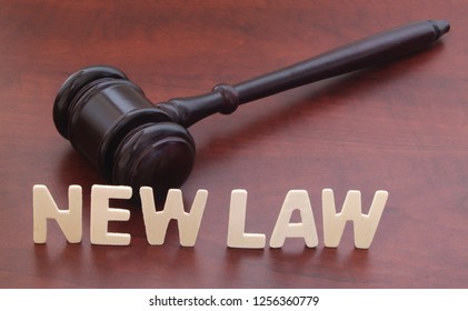 New Laws Concept. Words NEW LAW And Judge Gavel On Table.