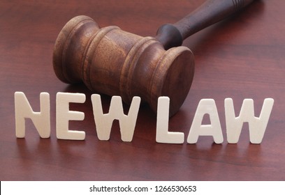 New Laws Concept. Words NEW LAW And Judge Gavel On Table.