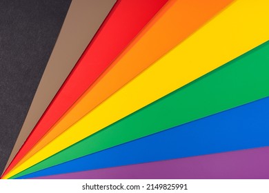 New LGBT Rainbow Flag Background With Black And Brown Stripes. Group Of Colored Cardboard. Gay Pride Flag