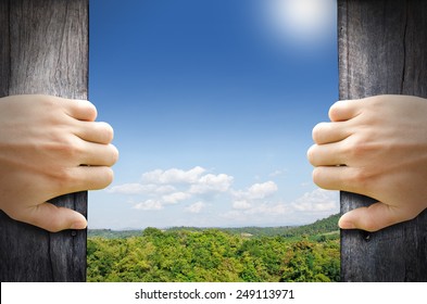 New Life Concept. 2 Hands Trying Open A Wooden Door To New World.