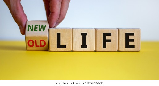 New life concept for fresh start, new year resolution, dieting and healthy lifestyle. Hand is turning a cube and changes the words 'old life' to 'new life'. Beautiful white background, copy space.