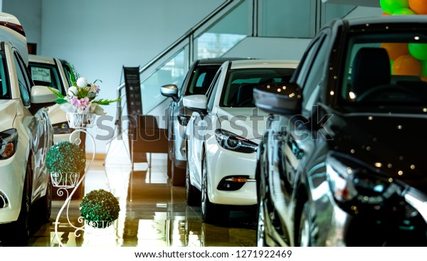 New luxury shiny compact car parked in modern\
showroom. Car dealership office. Car retail shop. Electric car\
technology and business concept. Automobile rental concept.\
Automotive industry.\
Promotions