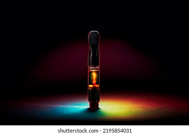 New Marijuana Vape Pen Cartridge With Radiant Rainbow Lighting And Dark Background.