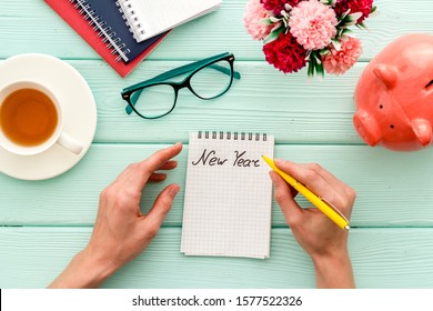 New me - planning self-development in New Year - notebook, women hand's writing, on cute hipster's green wooden desk top-down
