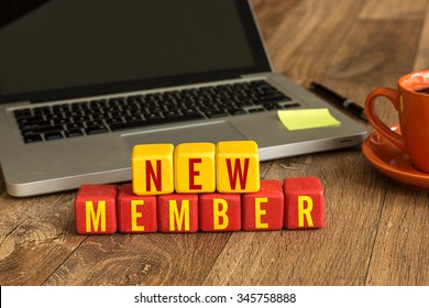 New Member Written On A Wooden Cube In A Office Desk