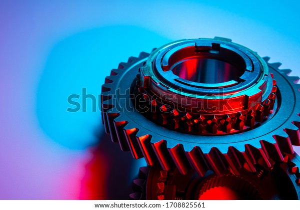 New metal gears spare parts for gearbox in\
two colors red and blue. Conceptual image of the mechanical\
elements of the\
transmission