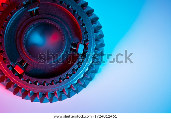 New metal gears spare parts for gearbox in\
two colors red and blue. Conceptual image of the mechanical\
elements of the\
transmission