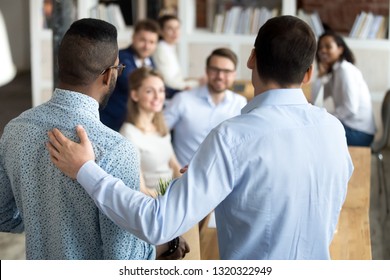 New mixed race employee having first working day in company standing in front of colleagues, executive manager employer introducing welcoming newcomer to workmates. Human resources employment concept