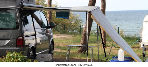 A New Mobile Home With Awning And Table And Chairs