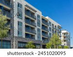 New modern apartment building with balconies and blue sky