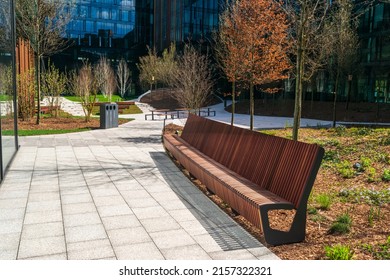 New modern bench in park. Outdoor city architecture, wooden outdoor chair, urban public furniture, empty plank seat, comfortable bench in recreation area