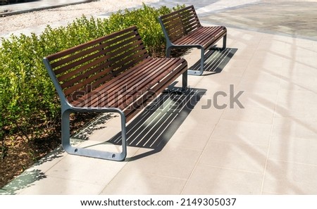 New modern bench in park. Outdoor city architecture, wooden benches, outdoor chair, urban public furniture, empty plank seat, comfortable bench in recreation area