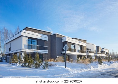 New modern block of flats in green area at winter. residential apartment with flat buildings exterior. luxury house complex covered snow. City Real estate property condo architecture insurance concept - Powered by Shutterstock