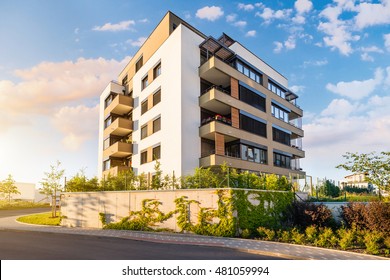 New modern block of flats in green area with blue sky - Shutterstock ID 481059994