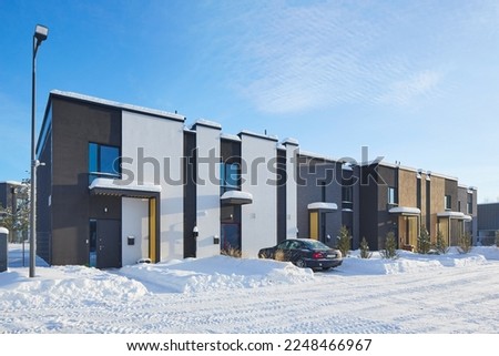 New modern block of flats in green area at winter. residential apartment with flat buildings exterior. luxury house complex covered snow. City Real estate property condo architecture insurance concept