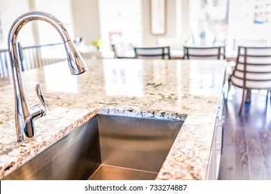 New Modern Faucet And Kitchen Room Sink Closeup With Island And Granite Countertops In Model House, Home, Apartment