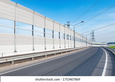 New Modern Highway With Noise Protection Fence Along It.