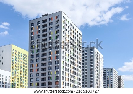 New modern monolithic residential apartment buildings on blue cloudy sky