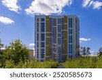 New modern residential building. Beautiful house on the background of a blue sky with clouds.