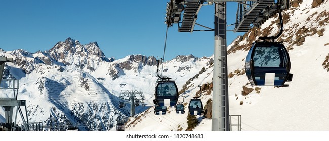 New modern spacious big cabin ski lift gondola pillar against snowcapped mountain peaks covered in snow landscape in luxury austrian winter resort Ischgl. Winter leisure sports, recreation and travel