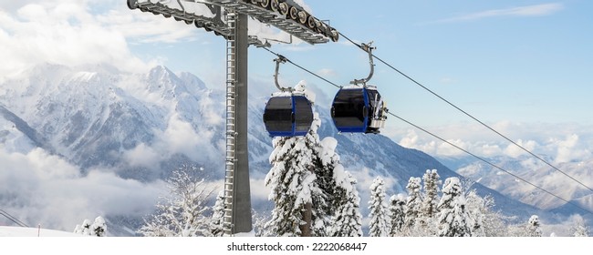 New modern spacious big cabin ski lift gondola against snowcapped forest tree and mountain peaks covered in snow landscape in luxury winter alpine resort. Winter leisure sports, recreation and travel - Shutterstock ID 2222068447