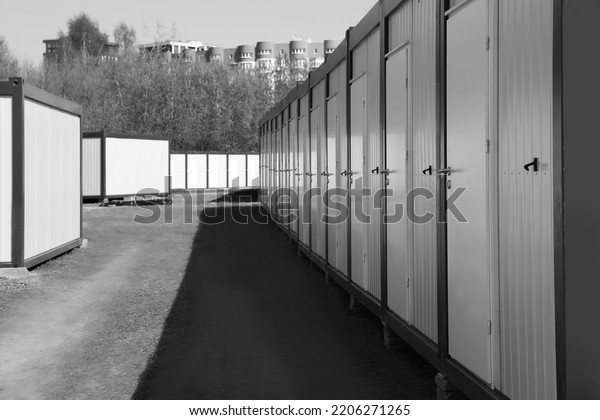 New modular houses for internally displaced\
persons outdoors. Black and white\
effect