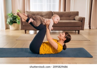 New mom lifting her adorable little baby with her legs, doing post-natal fitness exercise. Sports mother is engaged in fitness and yoga with a baby at home. Healthy motherhood and postpartum recovery