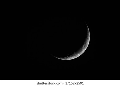 New Moon Rising On Dark Sky At Night