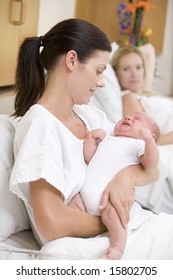 New Mother With Baby In Hospital Smiling