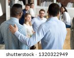 New multiracial employee having first working day in company standing in front of colleagues executive manager employer introducing welcoming newcomer to workmates. Human resources employment concept