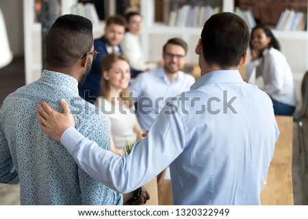 New multiracial employee having first working day in company standing in front of colleagues executive manager employer introducing welcoming newcomer to workmates. Human resources employment concept