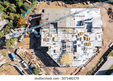 New Multi-story Building Under Construction. Construction Workers Pouring Wet Concrete Into Floor Slab Form. Aerial Top View