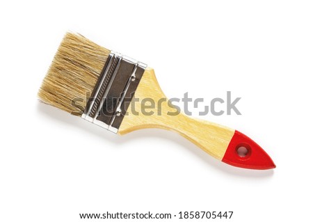 New natural bristle paint brush with red tip wooden handle isolated on white background. Design element for construction painting work, repair and redecorate concepts. Top view.