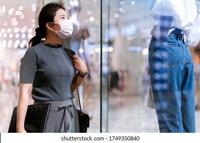 New Normal After Covid Epidemic Young Asian Female Wear Face Mask Protection Shopping Dress Or Cloth In Boutique Shop New Lifestyle In Department Store Mall Background