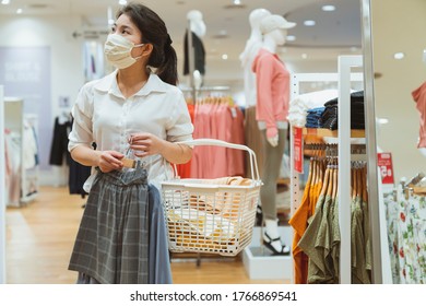 New Normal After Covid Epidemic Yound Asian Female Wear Face Mask Protection Shopping Dress Or Cloth In Boutique Shop New Lifestyle In Department Store Mall Background