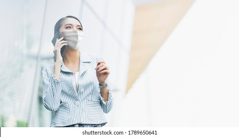 New Normal After Covid19 Epidemic Smart Asian Female Wear Protection Mask Hand Use Smartphone Communication In Department Store New Lifestyle Abstract Blur Background