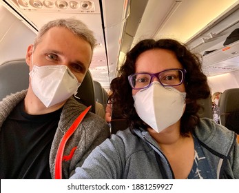 New Normal For Airplane Traveling - Couple Take A Selfie Photo Wearing Masks For Protection During A Flight.