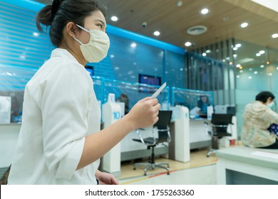 New Normal Asian Female Sit And Write Paper Work At Commercial Bank With Face Mask And Social Distancing New Lifestyle After Covid 19 Spread Epidemic