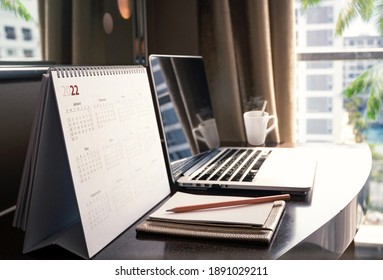 New Normal Concept: Close Up Desktop Calendar 2022 On Wooden Desk In Private Office