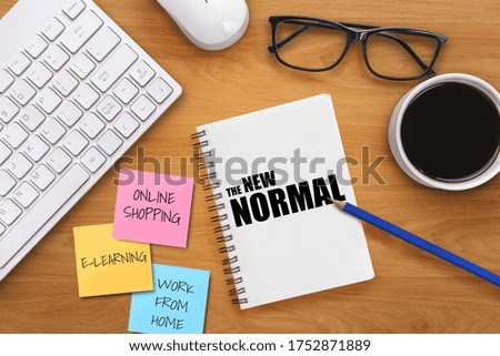 New normal concept effected by COVID 19 coronavirus that changes our lifestyle to new normal presented in word written in notebook on office desk when abnormal becomes new normal .