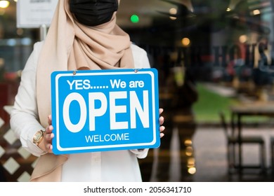 New Normal Concept: Hand holding open sign symbol of business re-opening after lockdown