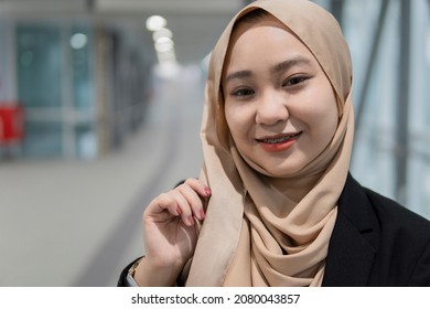 New Normal Concept: Young Malay Lady At The Train Station Smiling With Braces