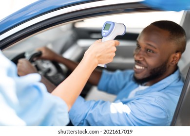 New Normal, Control, Pandemic, Covid-19 On Road In Transit. Medical Worker Measuring Temperature Of Young Black Male Driver Through Car Window Before Leaving Quarantine Zone Or Crossing Country Border