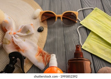 New Normal Covid Face Mask Hat Bag Sun Protection Sunglasses Sunscreen Spray Lotion Tan Ultra-violet Rays. Summer Background Template Mockup Free Space Pattern Composition Sample Text. Top View Above