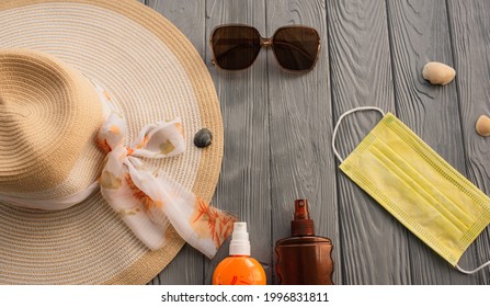 New Normal Covid Face Mask Hat Bag Sun Protection Sunglasses Sunscreen Spray Lotion Tan Ultra-violet Rays. Summer Background Template Mockup Free Space Pattern Composition Sample Text. Top View Above